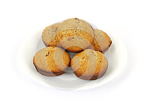 Fresh baked bran muffins on white plate