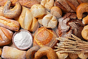 Fresh baked bread and wheat ears, top view