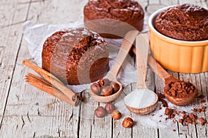 Fresh baked browny cakes, sugar, hazelnuts and cocoa powder