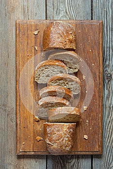 Fresh baked buckwheat (whole grain) bread, on a wooden background. Crispy baguette
