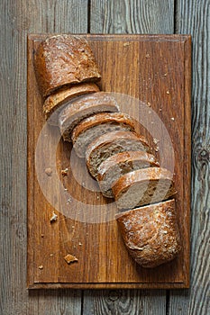 Fresh baked buckwheat (whole grain) bread, on a wooden background. Crispy baguette