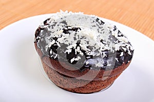 Fresh baked chocolate muffins with desiccated coconut photo