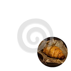 Fresh baked croissant on wrapping paper. copyspace. white background