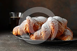 Croissants sprinkled with sugar powder photo