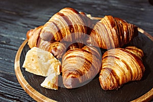 Fresh baked croissants. Warm fragrant butter croissants and rolls on a stone stand. French and American pastries
