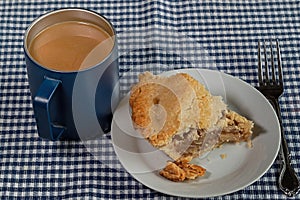 Fresh baked double crust apple pie with a cup of brewed coffee.