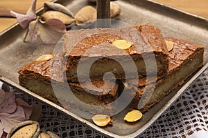 Fresh baked Dutch filled spicy cookies with almonds in autumn colors on dark wooden background