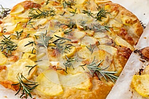Fresh baked focaccia or pala romana pizza with potato vegetables and rosemary in bakery in Parma, Emilia Romania, Italy photo