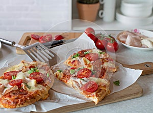 Fresh baked frozen pimped up pizza on kitchen counter