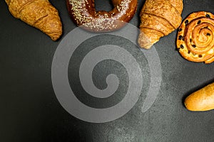 Fresh baked goods on a black background, with space for text