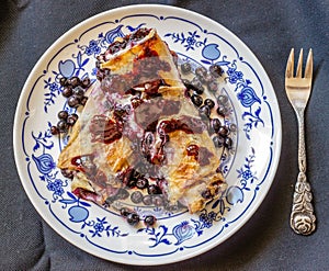 Fresh baked homemade blueberry pie on black background