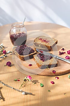 Fresh baked homemade healthy bread with blackcurrant jam