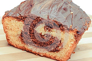 Fresh baked homemade marble cake with cocoa and chocolate icing