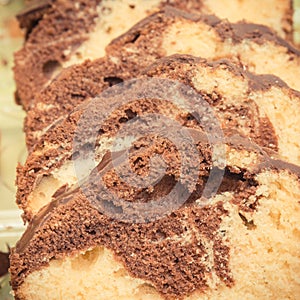 Fresh baked homemade marble cake with cocoa and chocolate icing