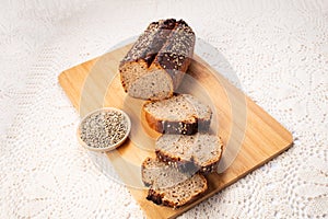 Fresh baked loaf of spelt sourdough bread with hemp seeds is on linen towel. Healthy pastry