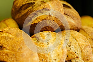 Fresh baked loaves of bread lying on the shelf in grocery store. Flavorful bakery in supermarket. Retail shop, food.