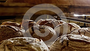 Fresh baked loaves of bread on a rack in a bakery. The concept o