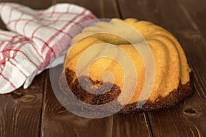 Fresh baked marble gugelhupf sweet bread on brown wood