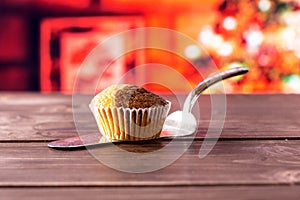 Fresh baked marble muffin with christmas tree behind