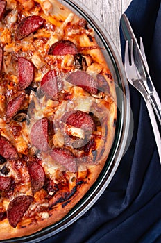 Fresh baked pepperoni pizza on a wooden surface