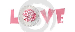 Fresh baked pink glazed cupcake decorated heart shape sprinkles on retro plate as letter O in word LOVE isolated on white