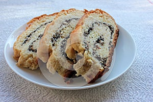 Fresh baked poppy seed pie. Homemade cake slices on the white plate