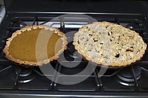 Fresh Baked Pumpkin and Apple Pie on Oven in Kitchen