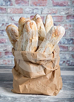 Fresh baked rustic bread loaves in paper bags