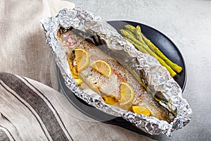 Fresh baked salmon trout in an aluminum foil