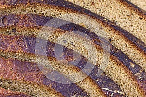 Fresh baked sliced black rye bread close up.