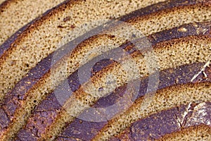 Fresh baked sliced black rye bread close up