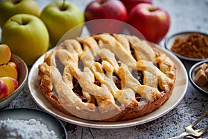 Fresh baked tasty homemade apple pie cake with ingredients on side