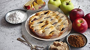 Fresh baked tasty homemade apple pie cake with ingredients on side