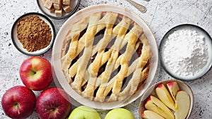 Fresh baked tasty homemade apple pie cake with ingredients on side