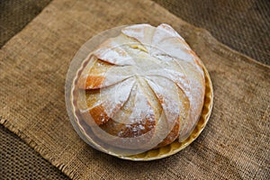 Fresh Bakery bread tray on the sack background homemade breakfast food concept - Round loaf of bread