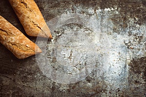 Fresh bakery food. Crusty loaves of baguettes on rustic table background. Top view and copy space for your advertising text