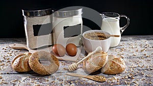 Fresh bakery supplies, milk, eggs, flour, grain and bun and bagels with eco friendly and wooden kitchen items