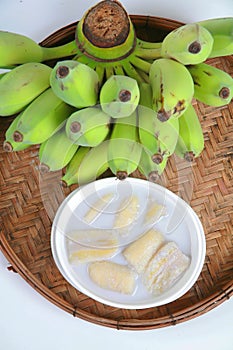 Fresh Banana and sweet desert in white plate .