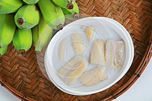 Fresh Banana and sweet desert in white plate .