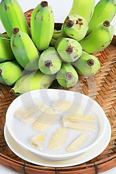 Fresh Banana and sweet desert in white plate .