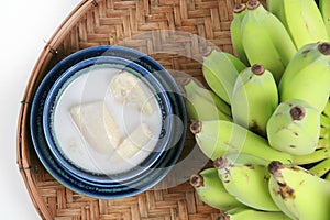 Fresh Banana and sweet desert in white plate .