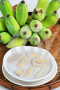 Fresh Banana and sweet desert in white plate .