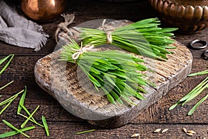 Fresh barley grass on a rustic table