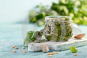 Fresh basil pesto sauce in glass jar