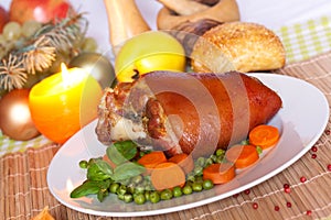 Fresh Bavarian roasted knuckle of pork with carrot