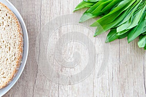 Fresh bear garlic on wooden table