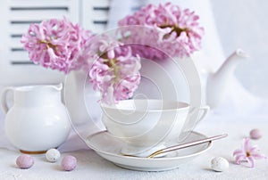 Fresh beautiful bouquet of pink hyacinths and a cup of coffee - breakfast for Mother`s Day, Easter