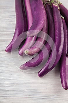 Fresh, beautiful purple violet eggplants decorated on a white wood table, studio shoot