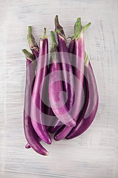 Fresh, beautiful purple violet eggplants decorated on a white wood table, studio shoot
