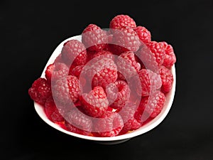 Fresh beautiful raspberries in a white bowl